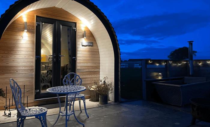 Glamping pod at night showing dark skies and mood lighting